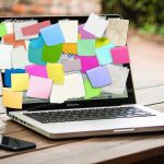 laptop covered in post it notes