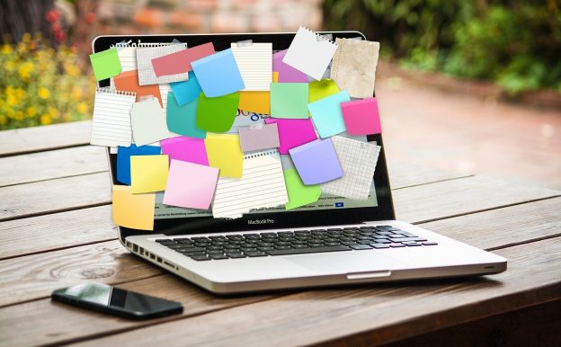laptop covered in post it notes