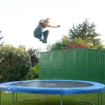 A youth bouncing on a trampoline