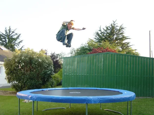 A youth bouncing on a trampoline