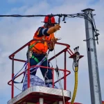 Engineer fixing power oat pole