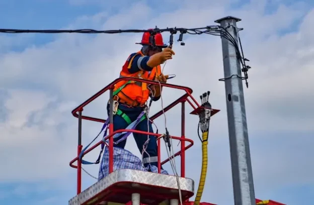 Engineer fixing power oat pole