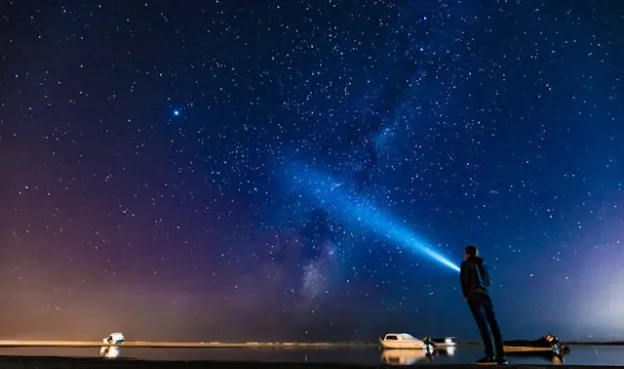 Flashlight to night sky