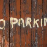 No Parking written on Fence