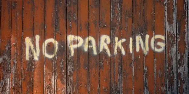 No Parking written on Fence