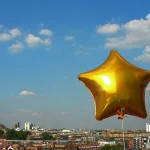 City view behind star balloon