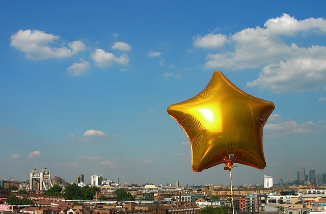City view behind star balloon