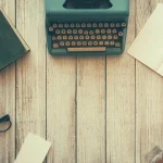 typewriter book and desk